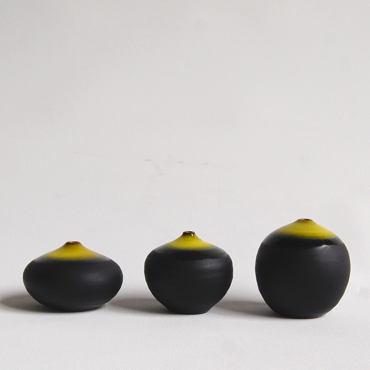 Trio of black and yellow miniature ceramics Antonio Lampecco