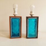 Two Swedish table lamps in solid pressed blue glass and teak wood "frame".