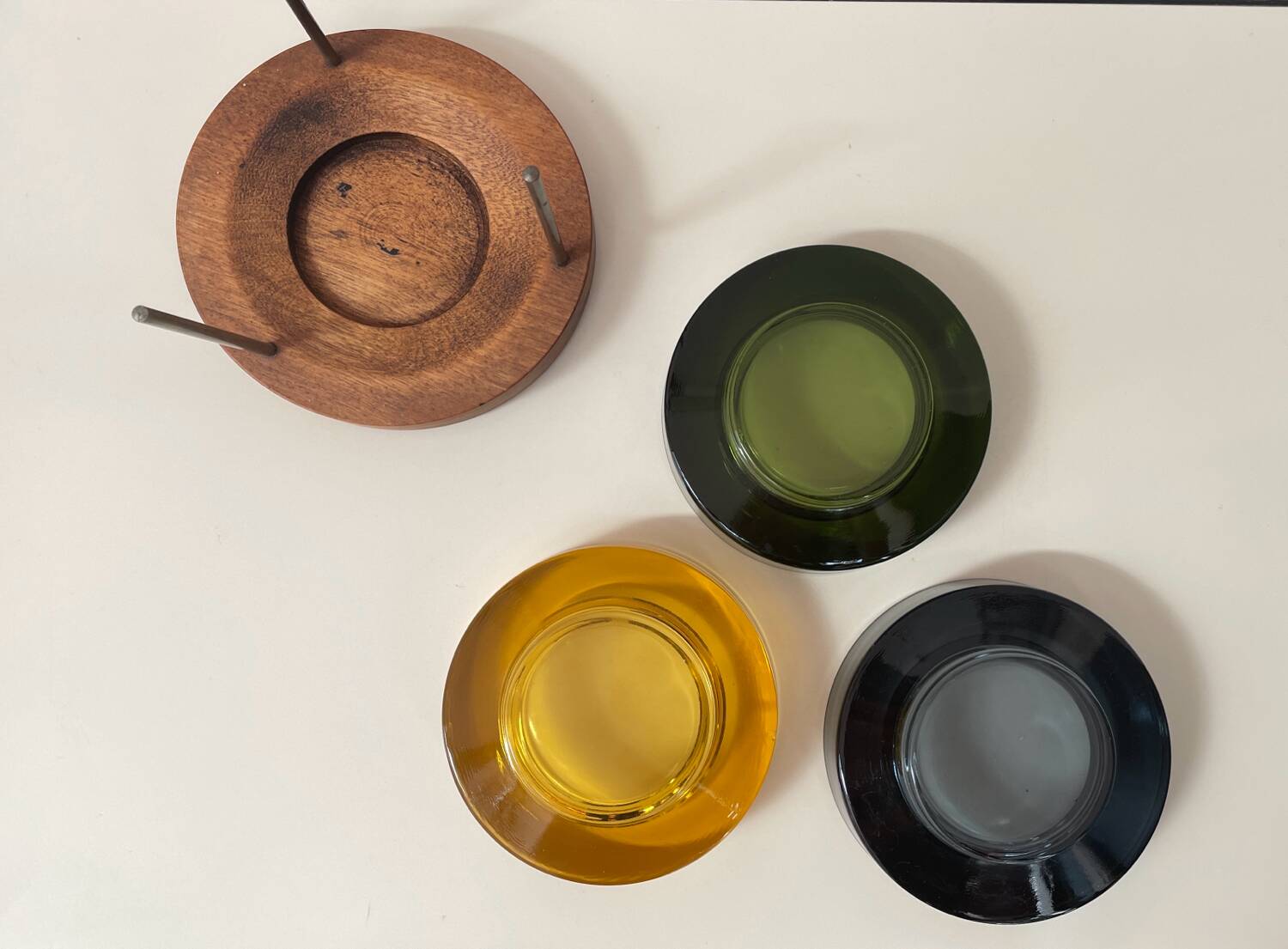 Set of 3 stackable glass catchalls with a teak base.