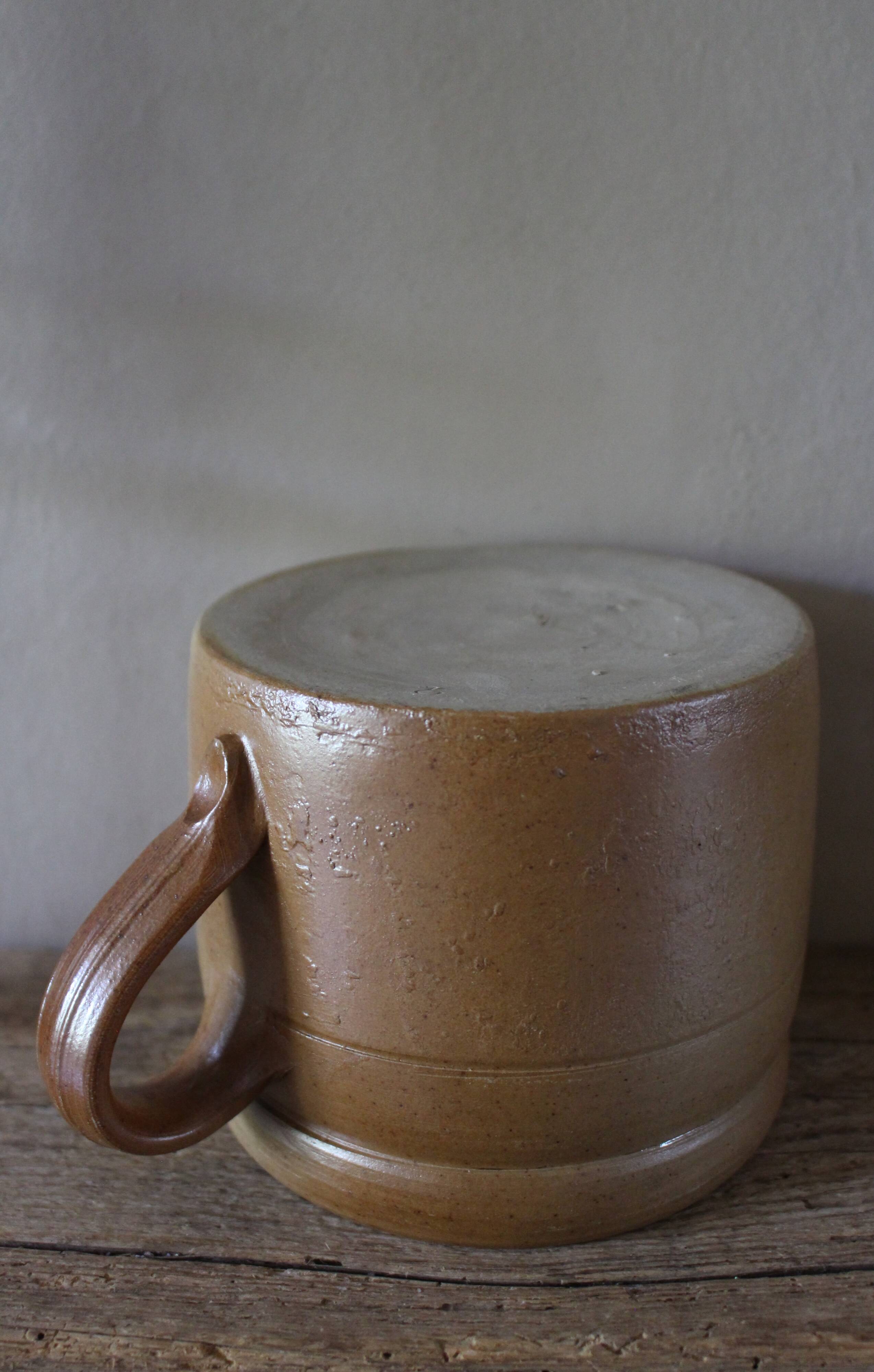 Vase terracotta milk jug with a glazed interior handle.