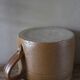 Vase terracotta milk jug with a glazed interior handle.