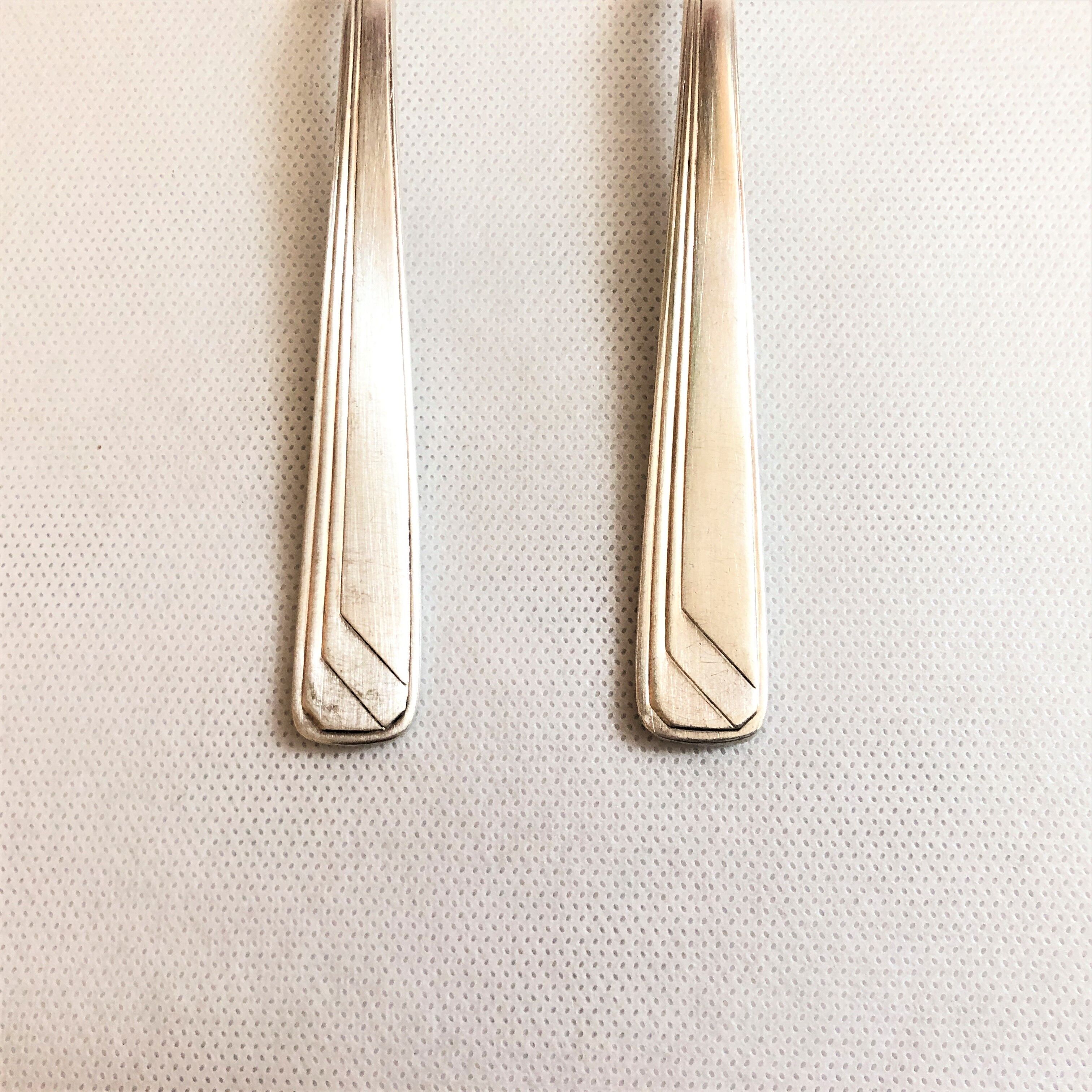 Set of 2 silver metal cutlery with punches
