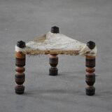 Vintage African artisanal stool, triangular shape with 3 legs, cowhide, 20th century.