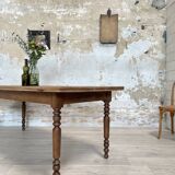 Vintage farmhouse table with turned legs.