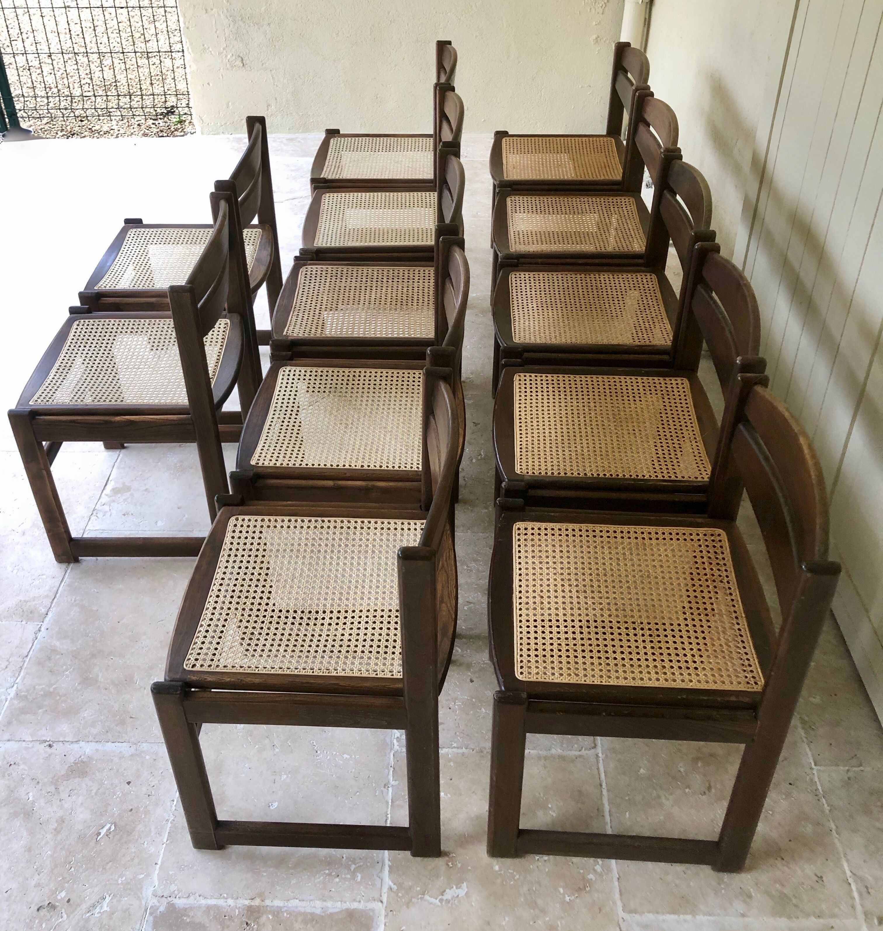 Set of 12 "sledge" dining chairs in walnut and cane.