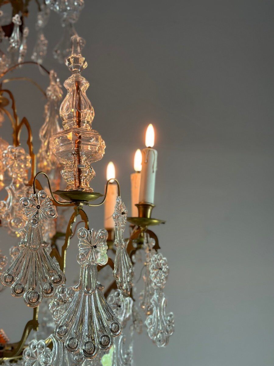 Bronze cage chandelier adorned with molded glass pendants in the shape of peacock feathers, circa 1800