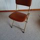 Chaise pliante structure tube et simili cuir