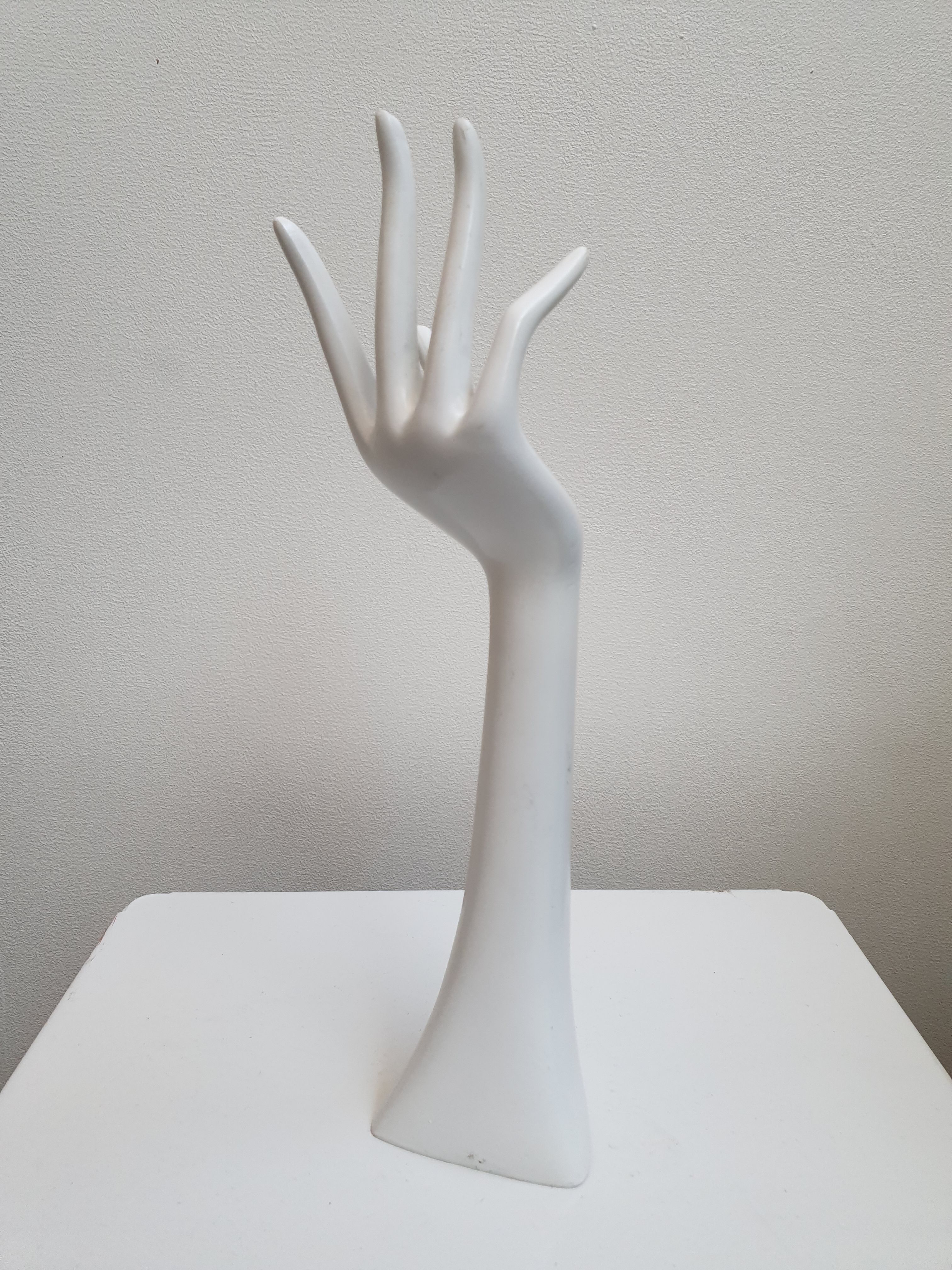 Hand wears white resin jewelry