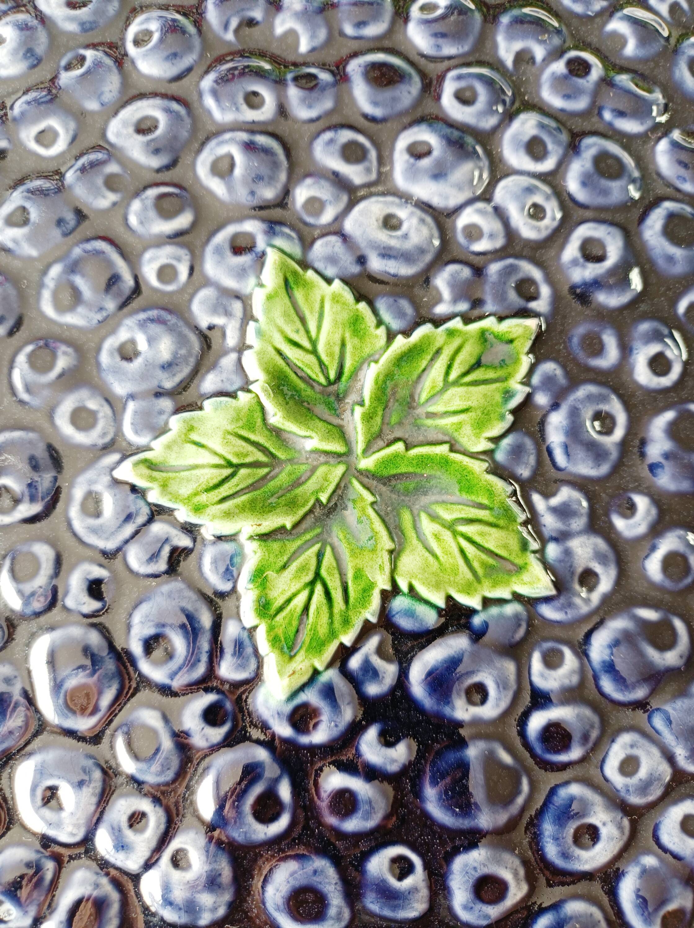 Pie dish on foot, in slip with blackberry decoration