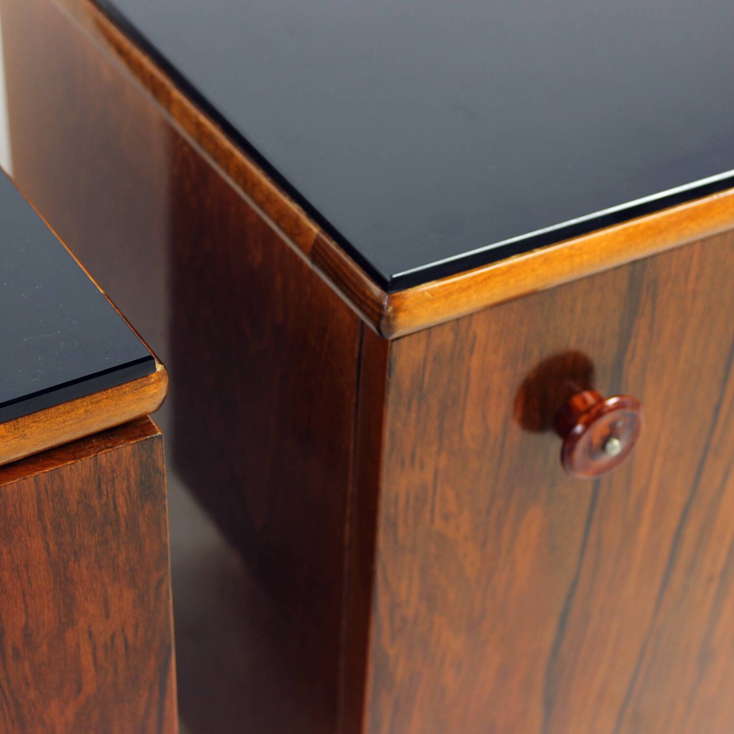 Pair of Art Deco bedside tables in walnut and black glass, Czechoslovakia.
