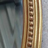Old oval beveled golden mirror