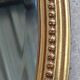 Old oval beveled golden mirror