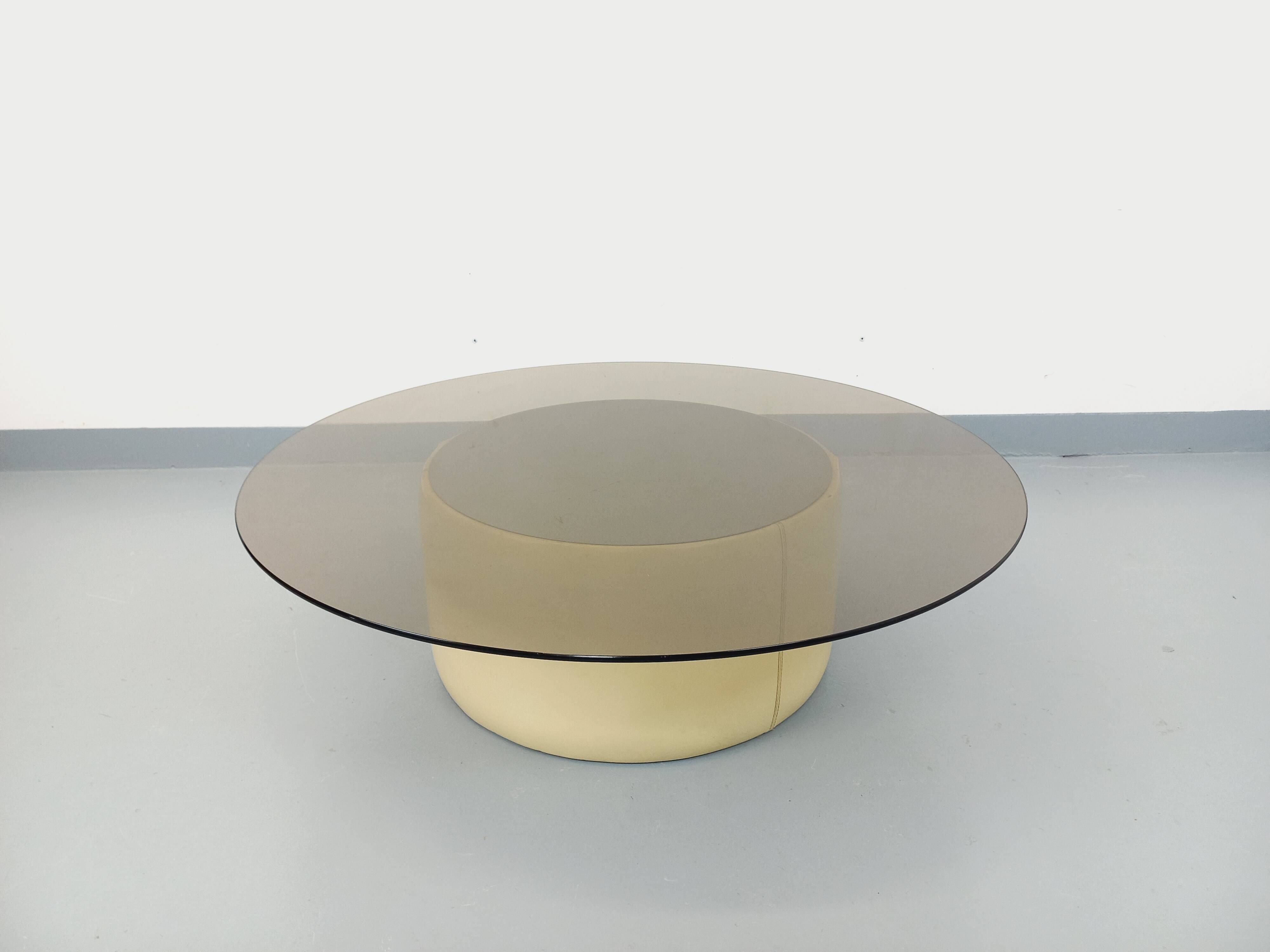 Vintage round coffee table in glass, leather, and metal in Space Age style from the 70s.