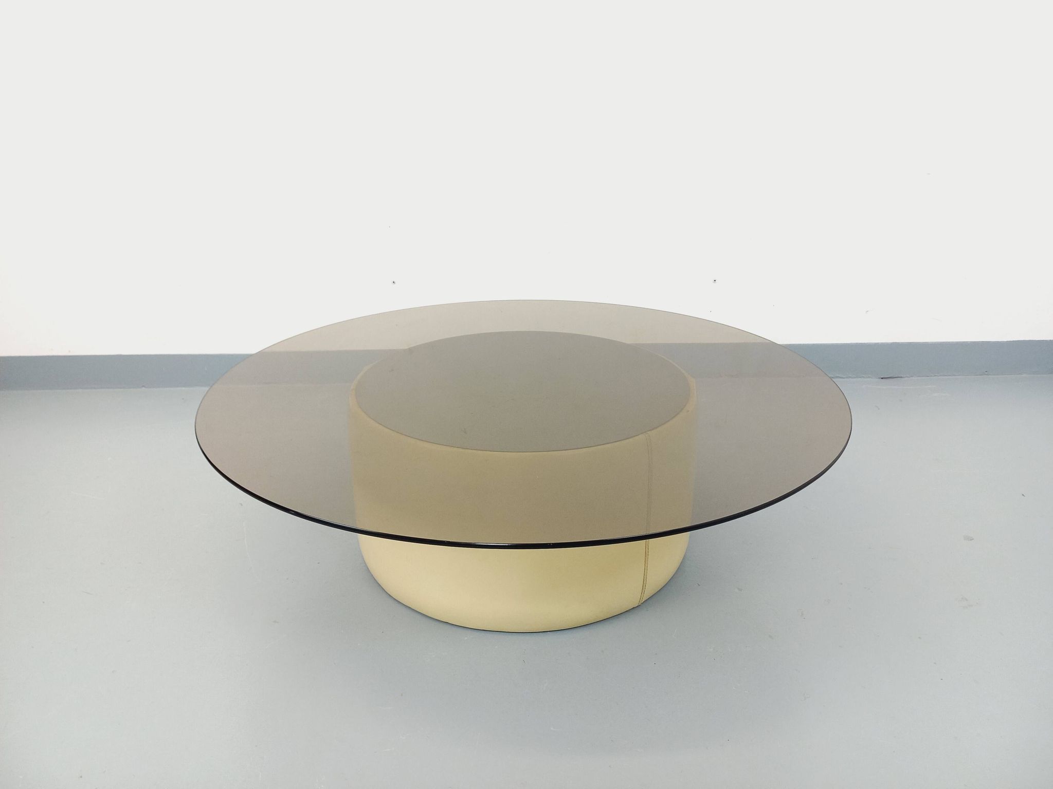 Vintage round coffee table in glass, leather, and metal in Space Age style from the 70s.