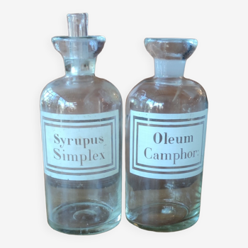 Two old Syrupus Simplex Oleum Camphor pharmacy bottles