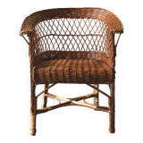 Woven rattan armchair with armrests.
