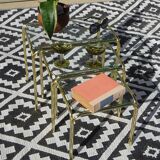 Nested tubular tables in gold metal.