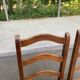 2 dining chairs in solid wood and rush, Chippendale ladder style.