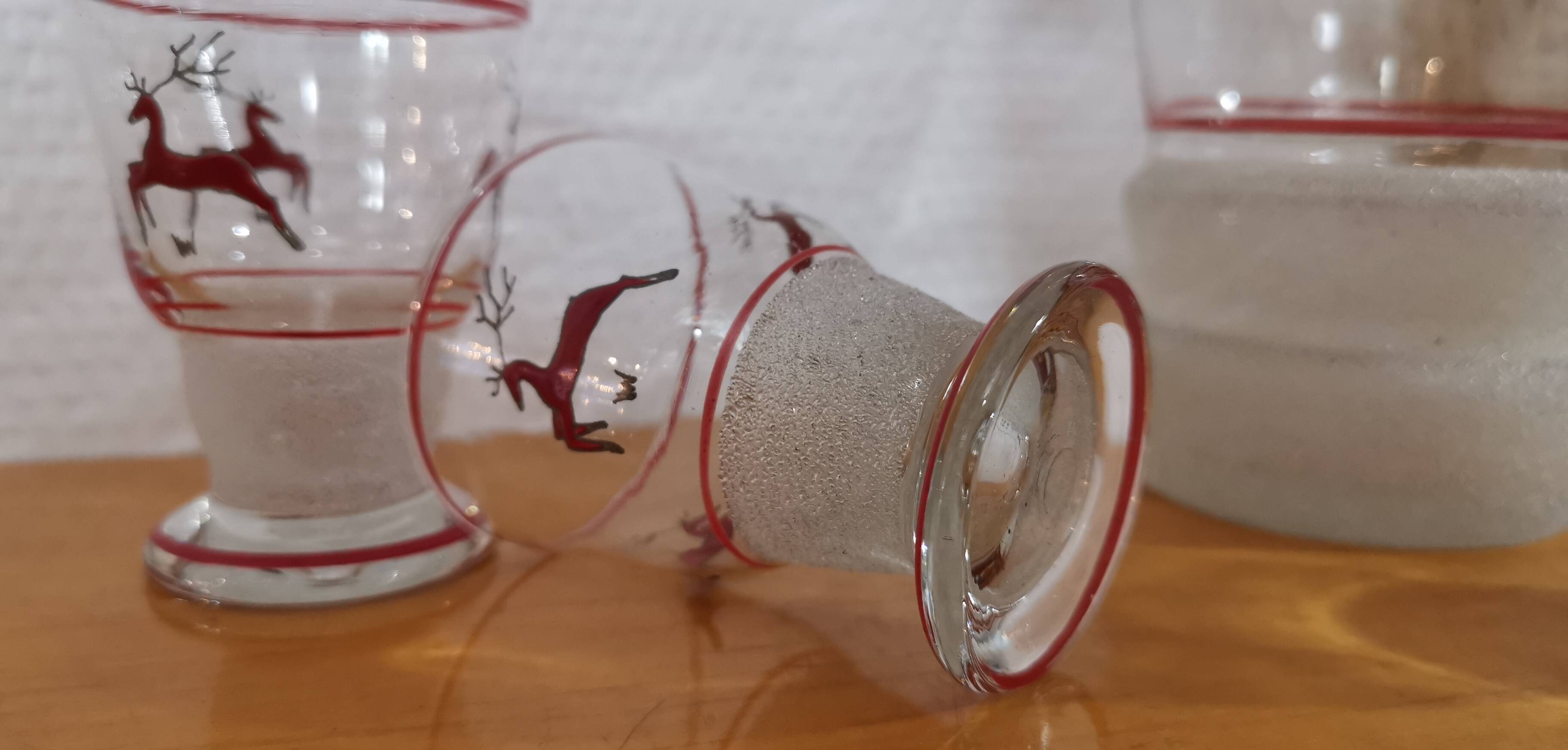 Glasses and carafe decorated with red Christmas reindeer and white granita 60's