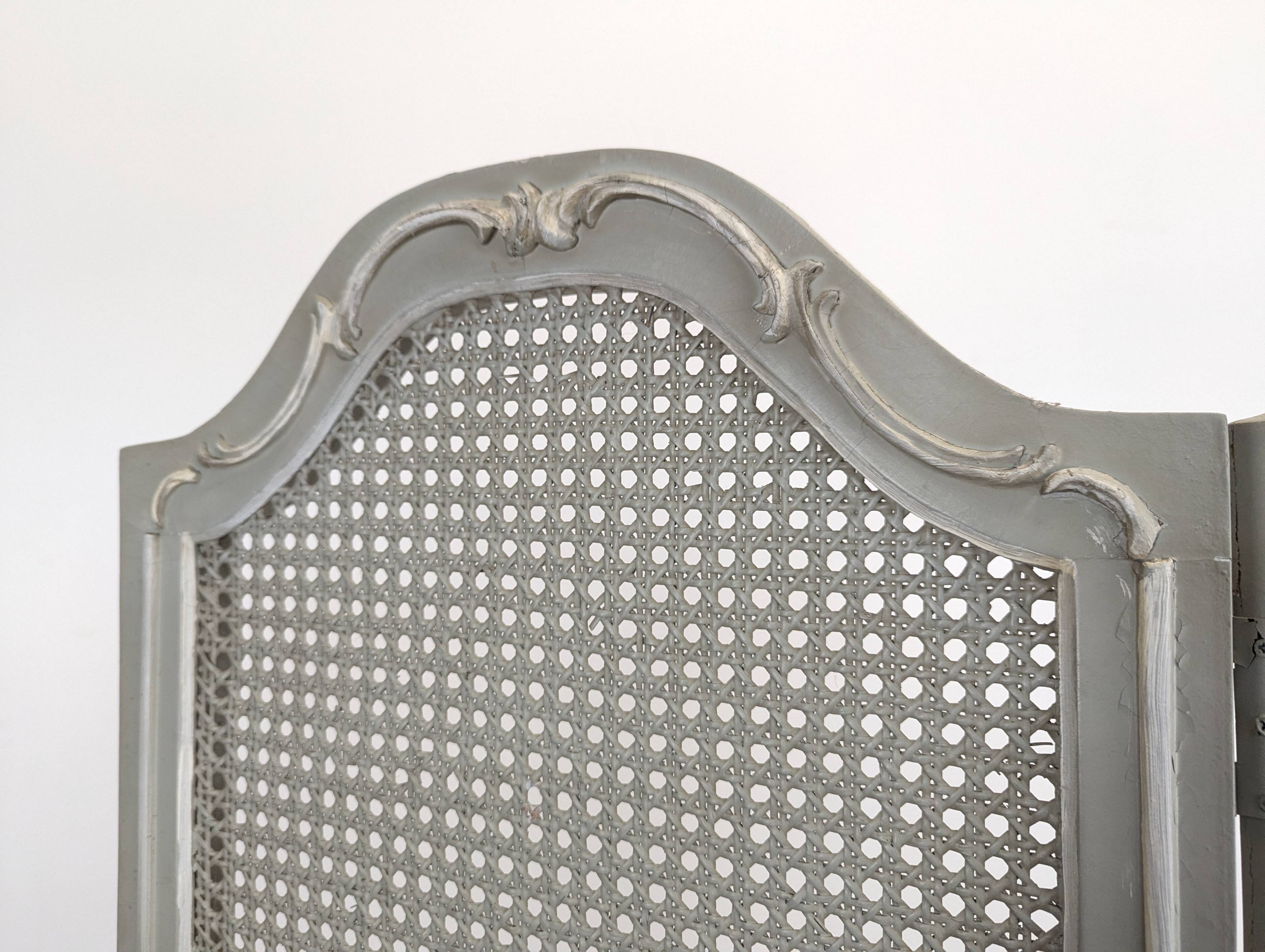 Louis XVI style caned screen with a re-champis finish.