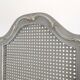 Louis XVI style caned screen with a re-champis finish.