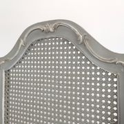 Louis XVI style caned screen with a re-champis finish.