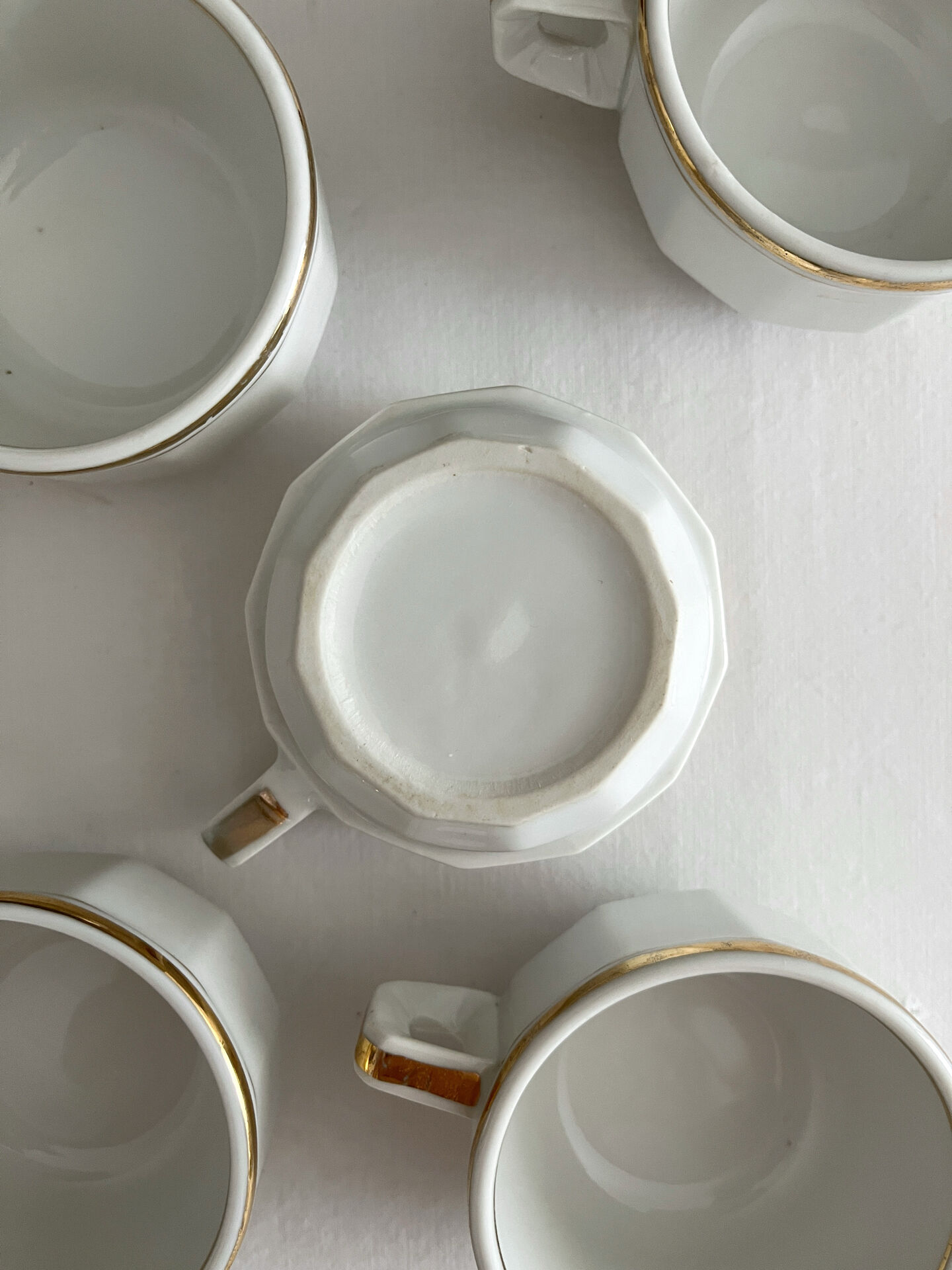 5 vintage porcelain bistro coffee cups from Paris with gold trim.