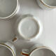 5 vintage porcelain bistro coffee cups from Paris with gold trim.