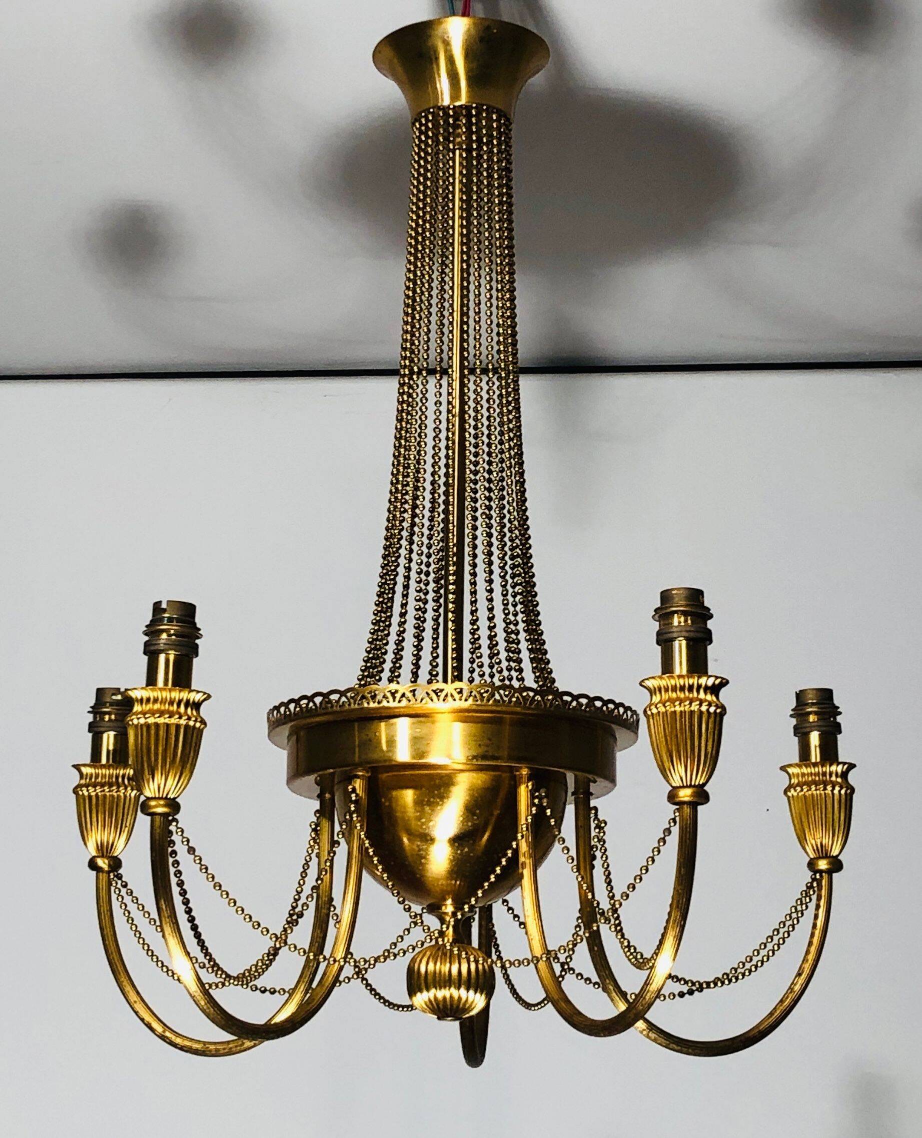 Neoclassical style brass chandelier decorated with pearl garlands