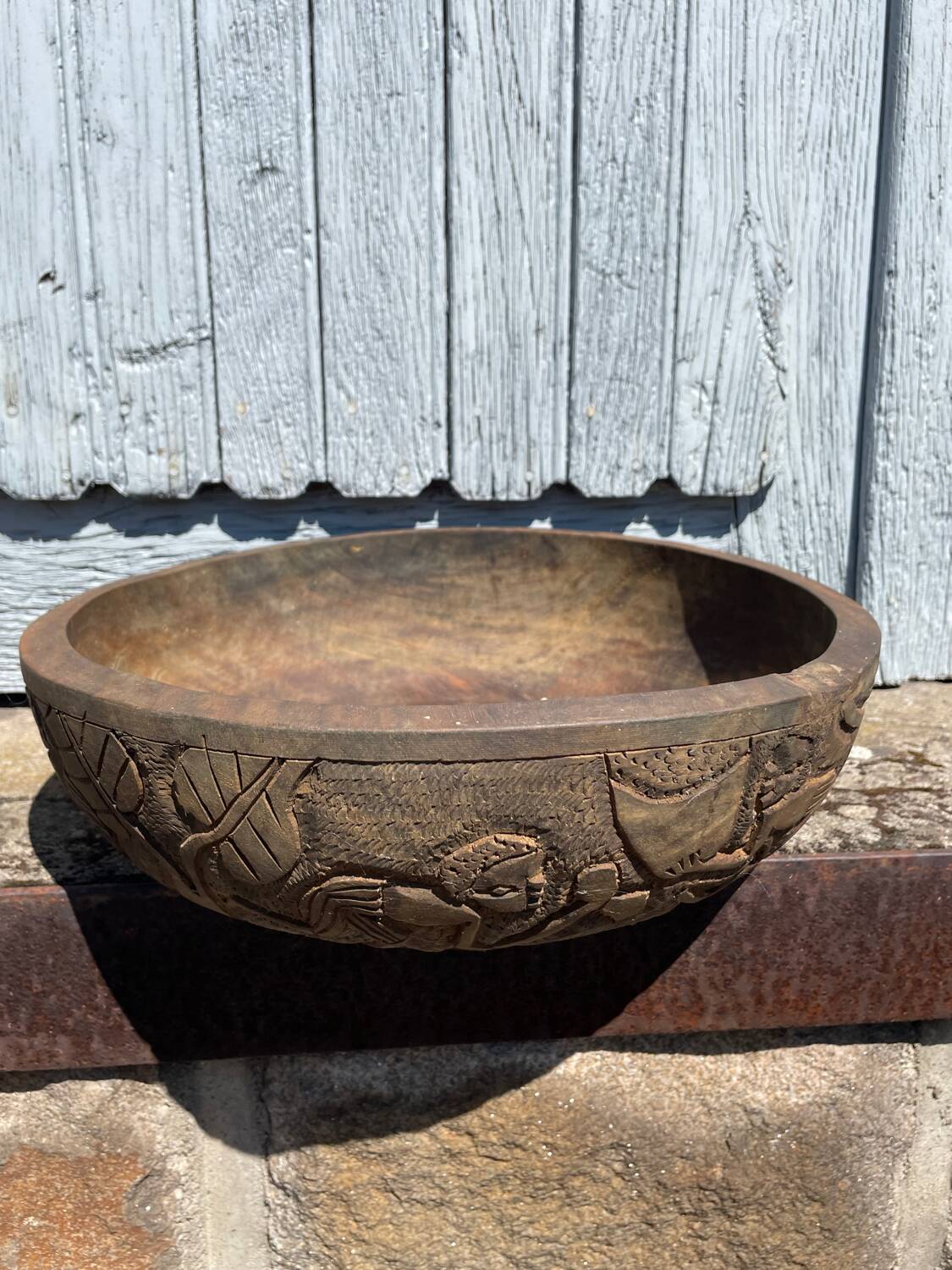Old carved wooden bowl with African decoration.