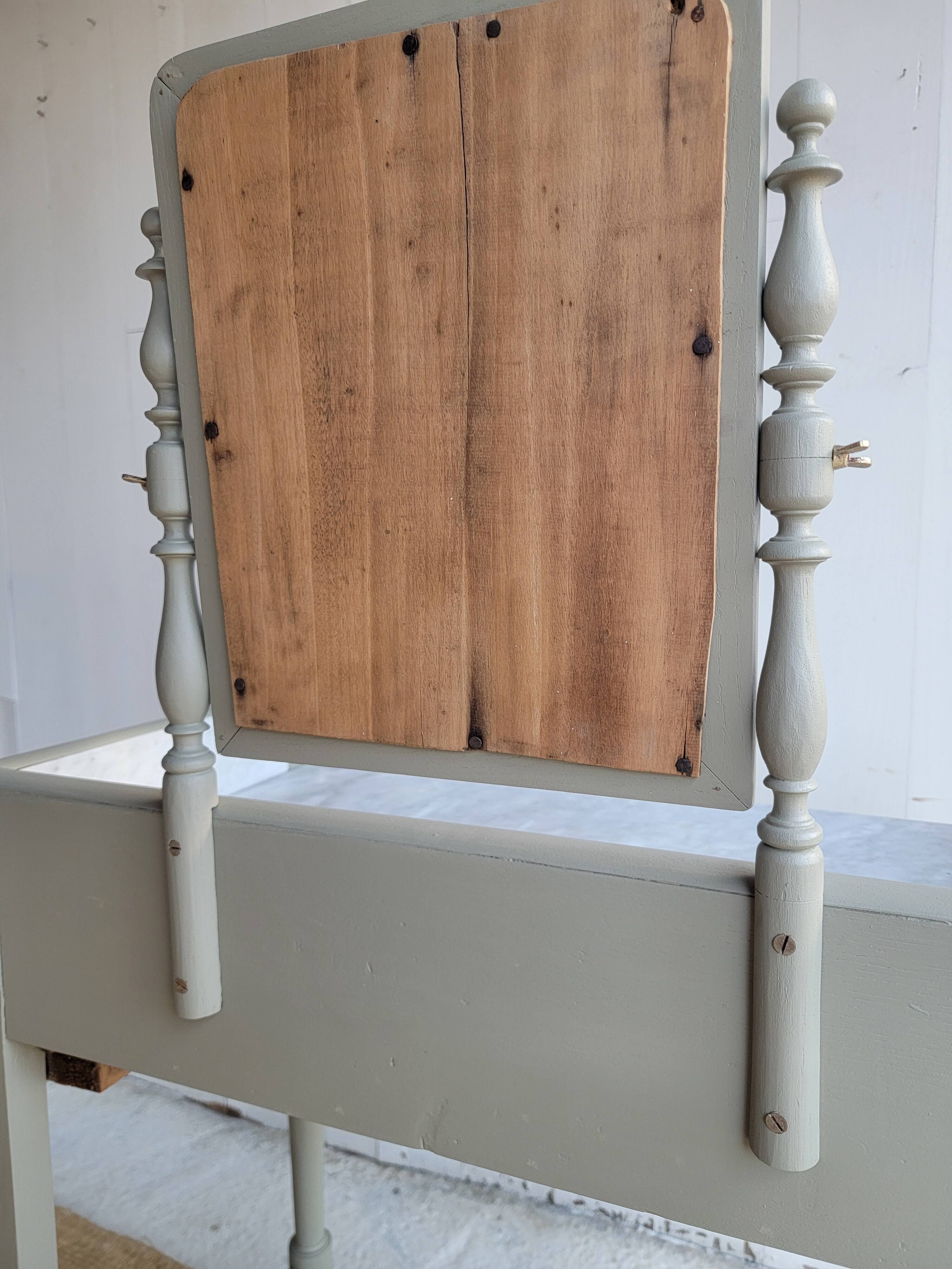 Antique wooden dressing table with marble top and mirror.