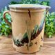 Large vintage ceramic pitcher with abstract green and brown decoration.