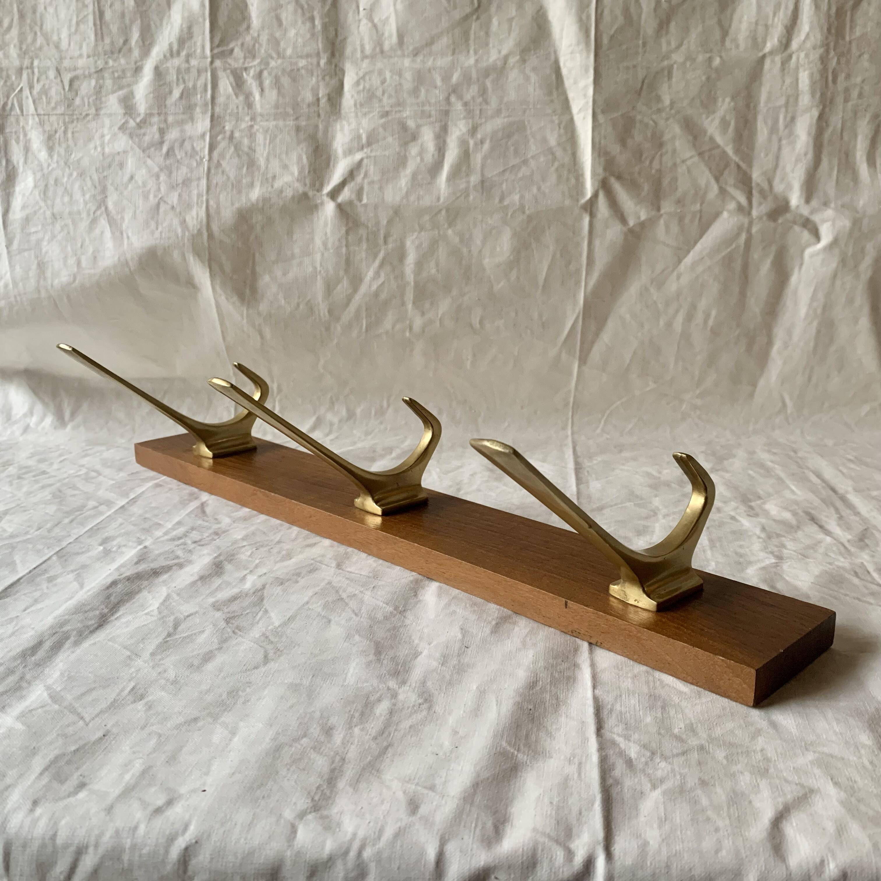 Vintage wooden wall-mounted coat rack with 3 golden cast aluminum hooks