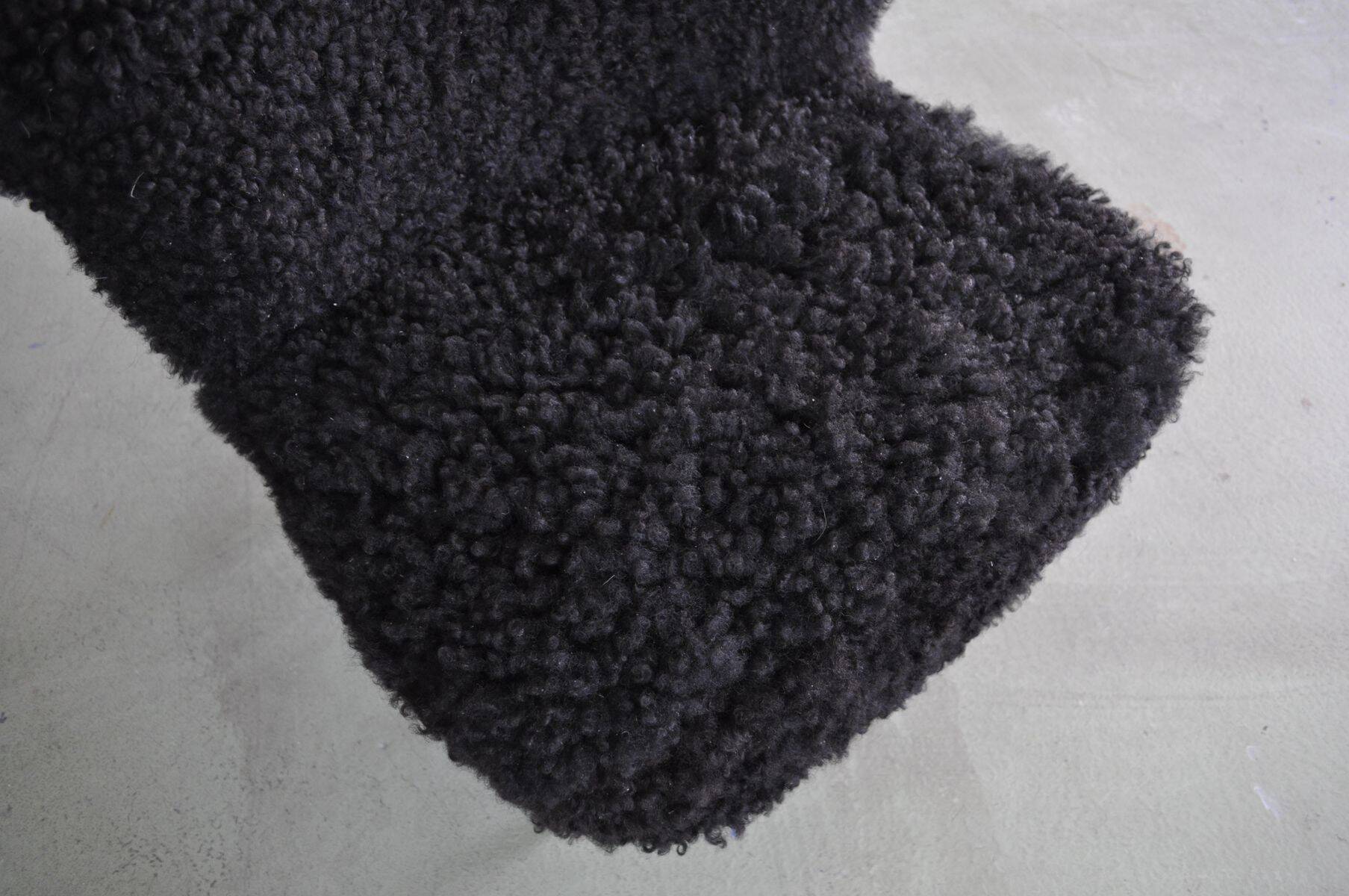 Mid-century black cocktail chair in lambskin, beech legs — 1960s