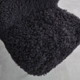 Mid-century black cocktail chair in lambskin, beech legs — 1960s