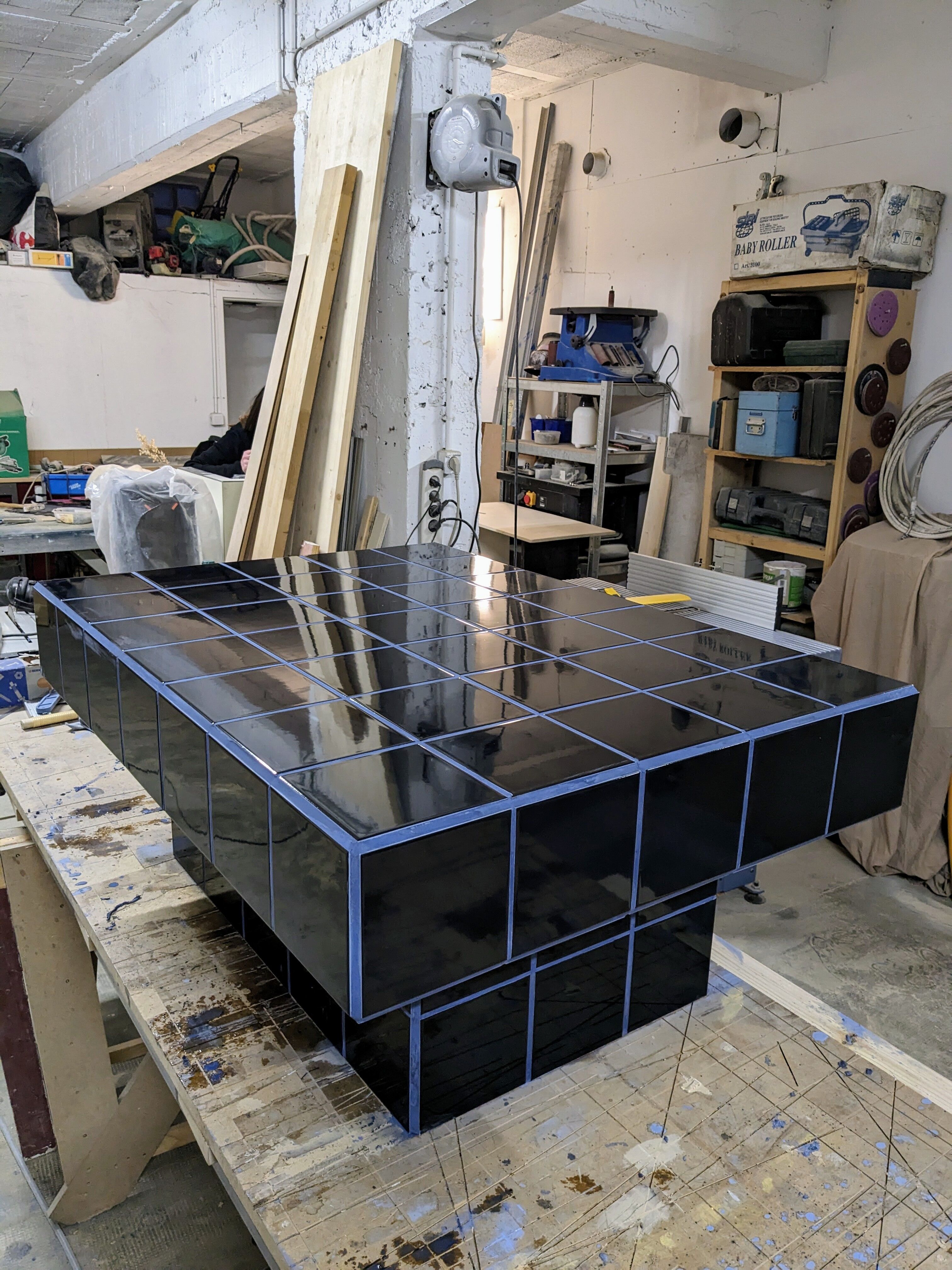 Black tiled coffee table and midnight blue grout