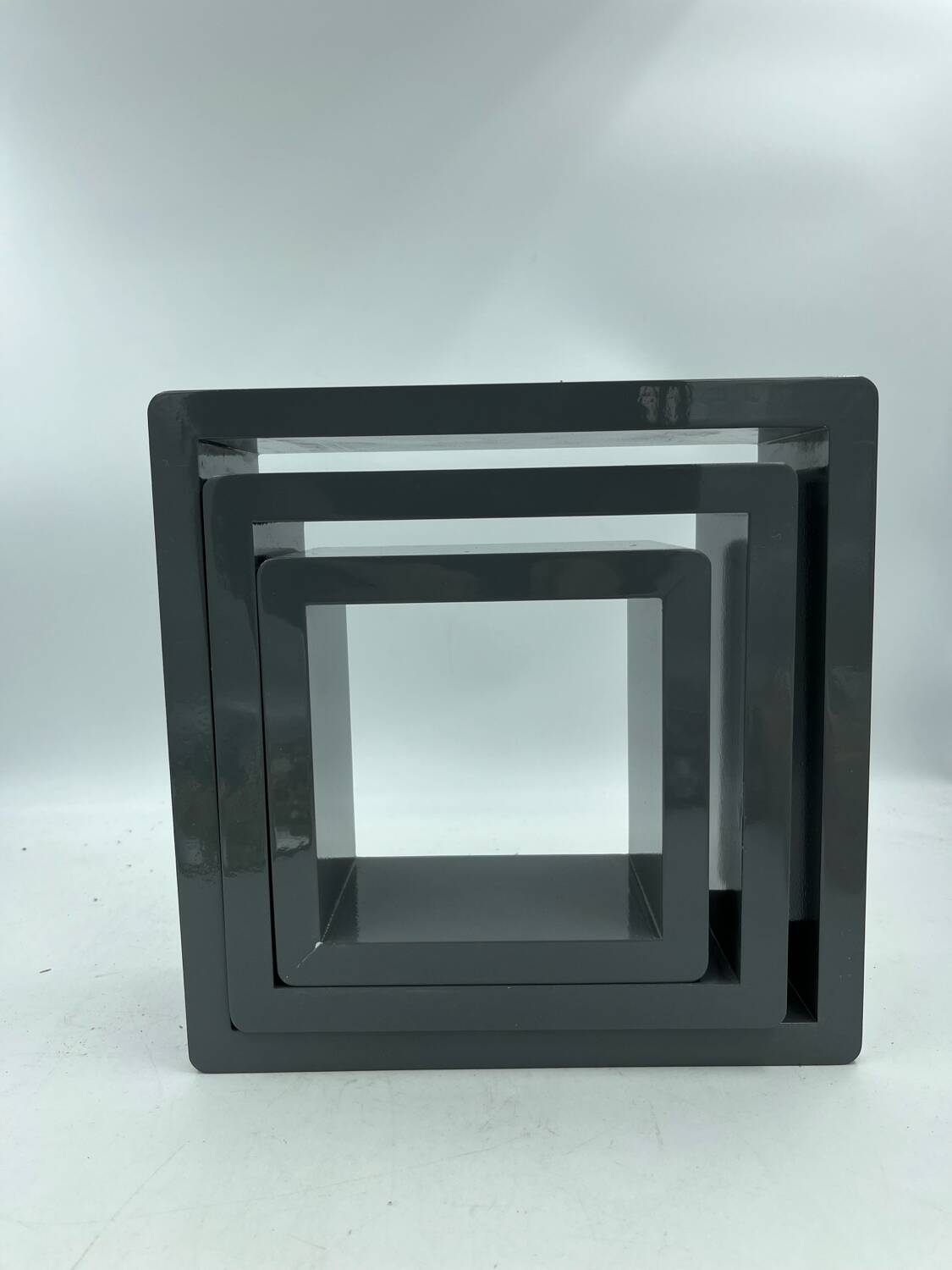 3 nesting shelves in grey lacquer.