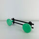 Wall-mounted coat rack with 2 green hooks from the 1950s.
