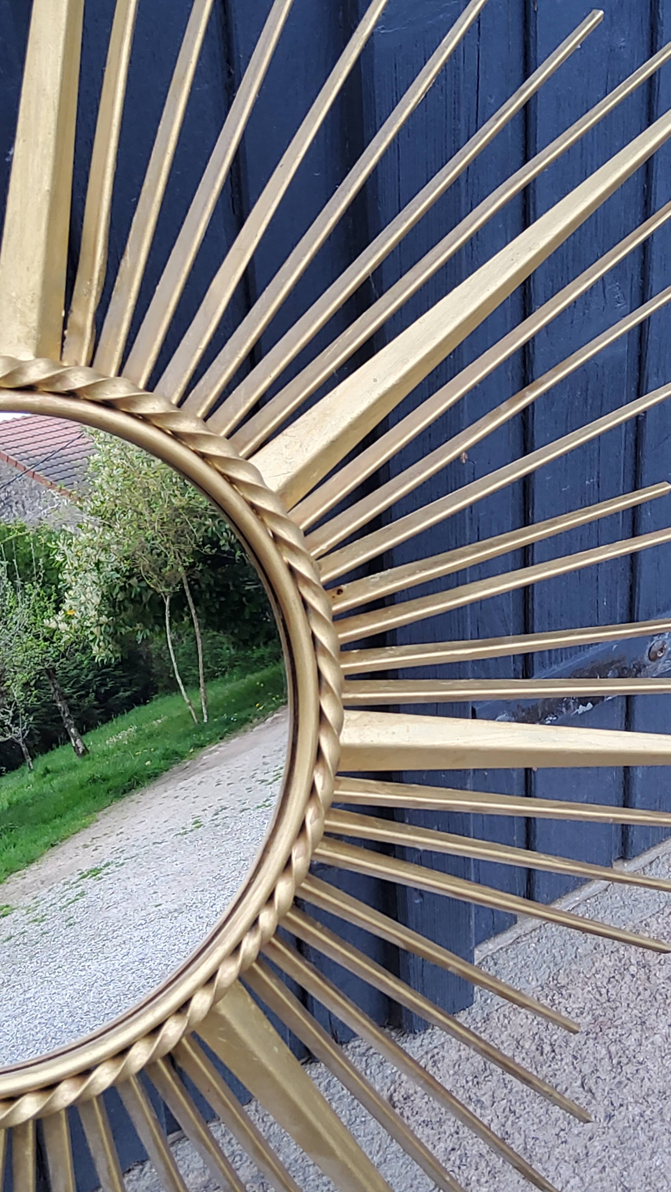 Miroir soleil Chaty Vallauris en métal doré