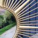 Miroir soleil Chaty Vallauris en métal doré