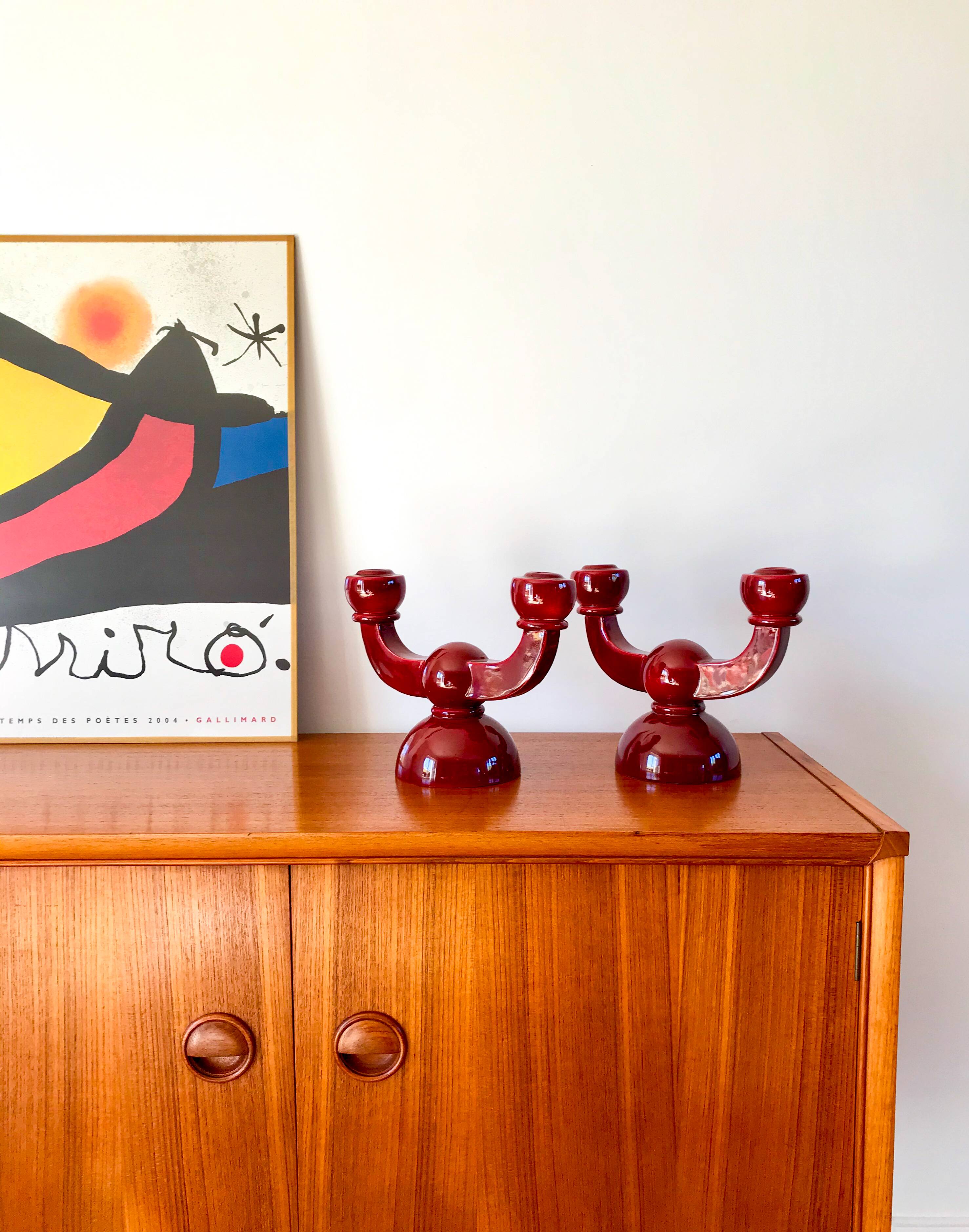 pair of burgundy enameled ceramic candlesticks / candelabras signed 1949