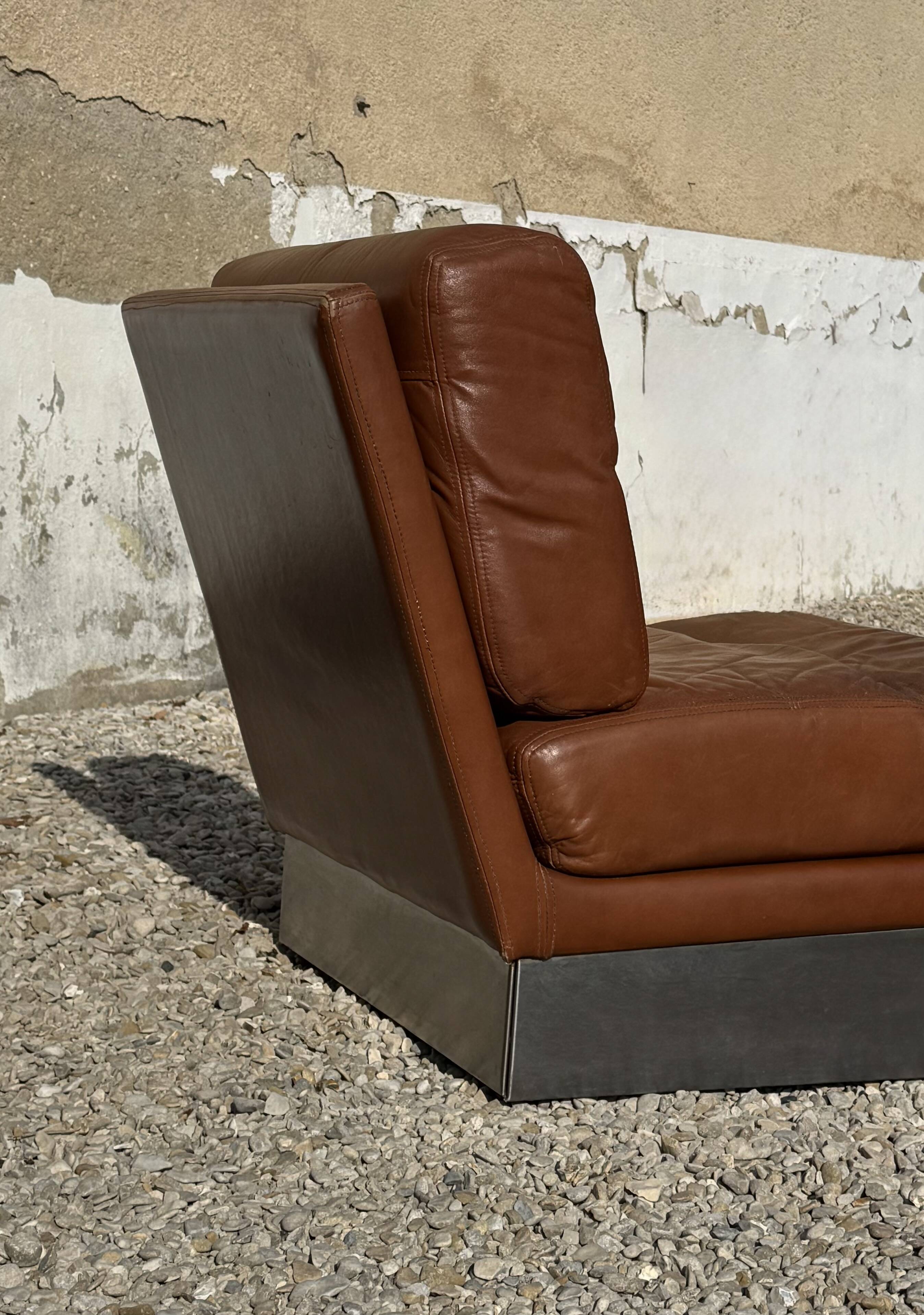2 armchairs and 1 ottoman in brushed aluminium and brown leather, France 1970