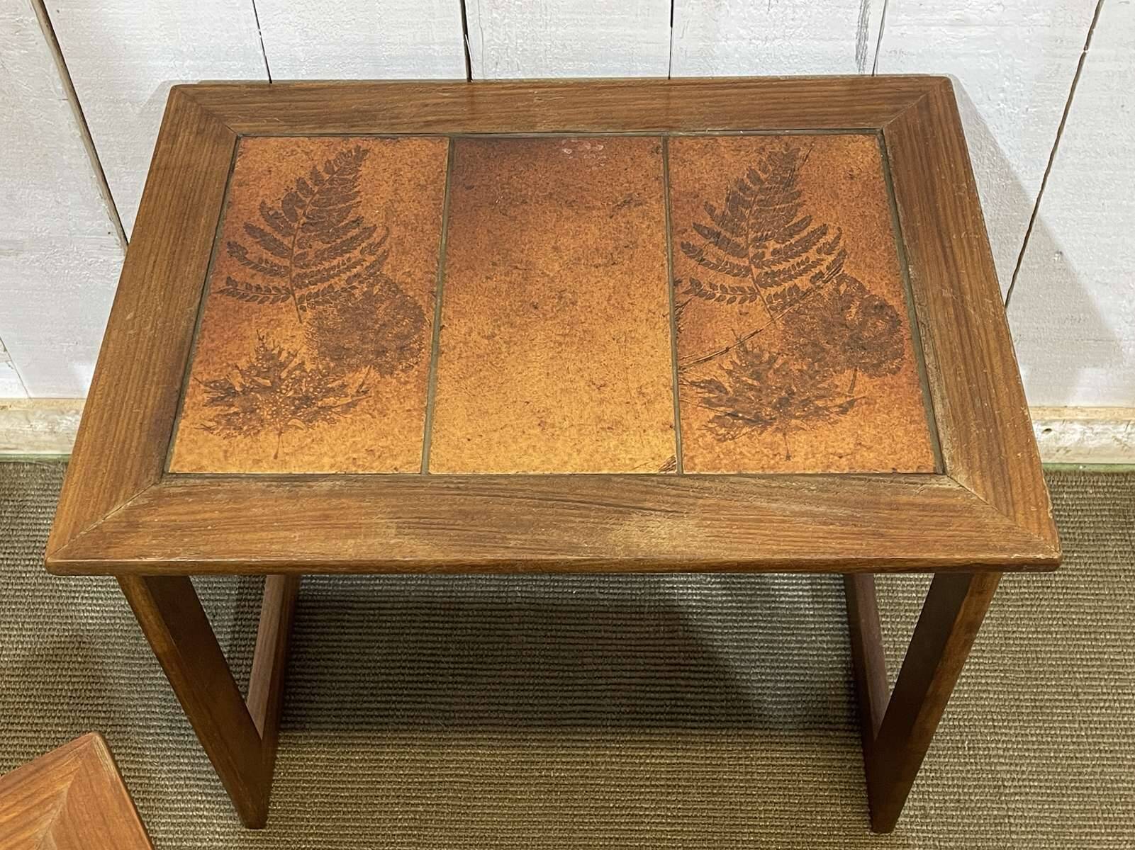 Set of 3 nesting tables in teak with tiled tops.