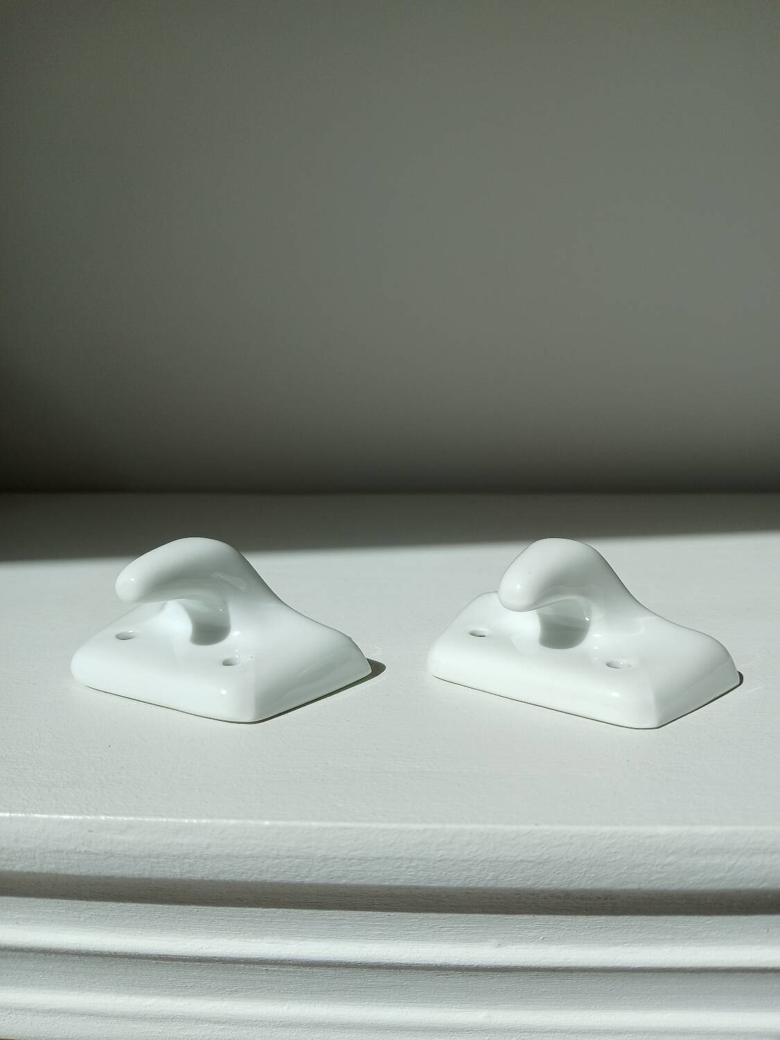 Set of two porcelain tea towel holders