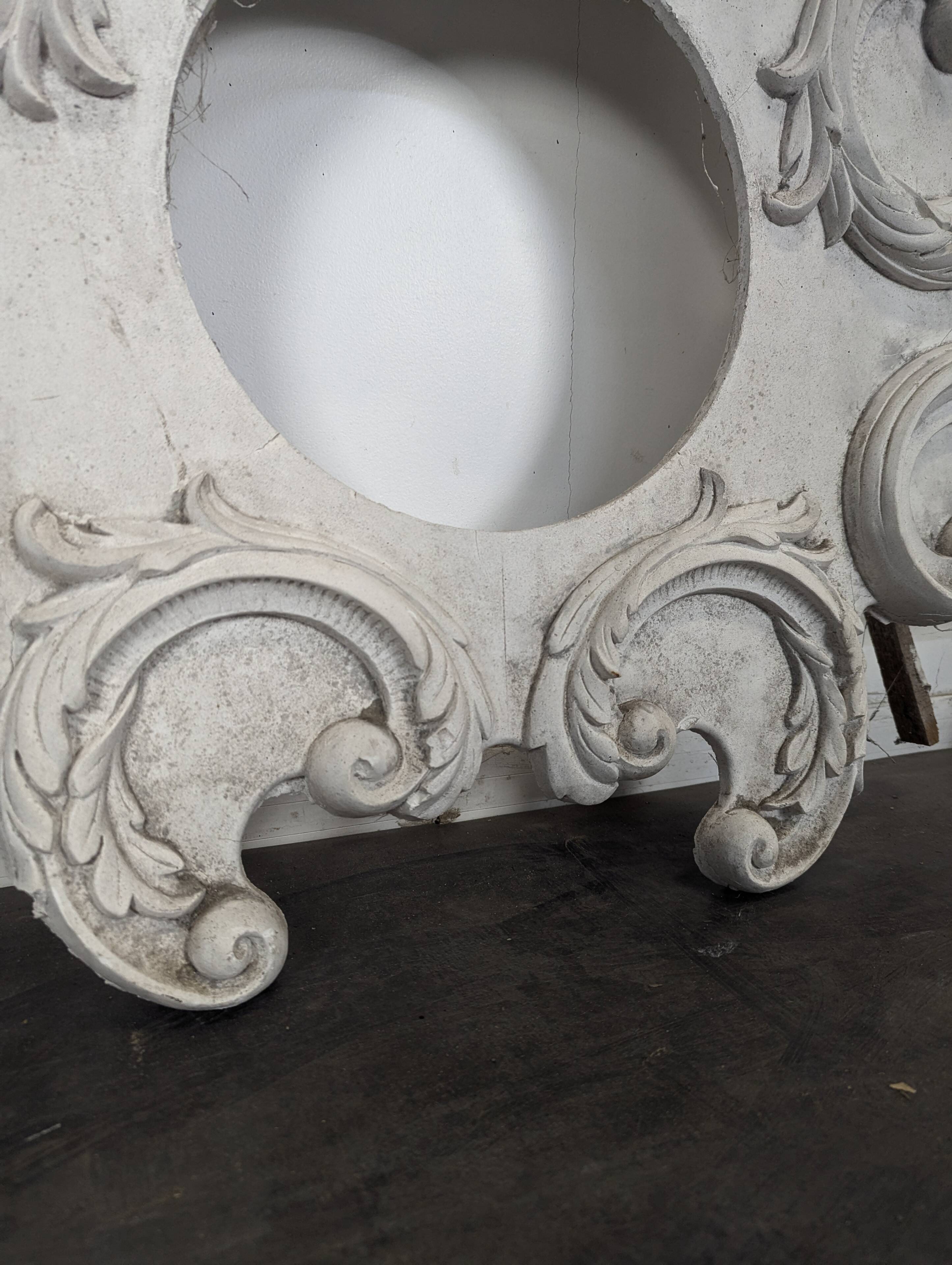 Large rococo fronton in stucco and carved wood, patinated white with an oculus.