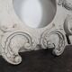 Large rococo fronton in stucco and carved wood, patinated white with an oculus.