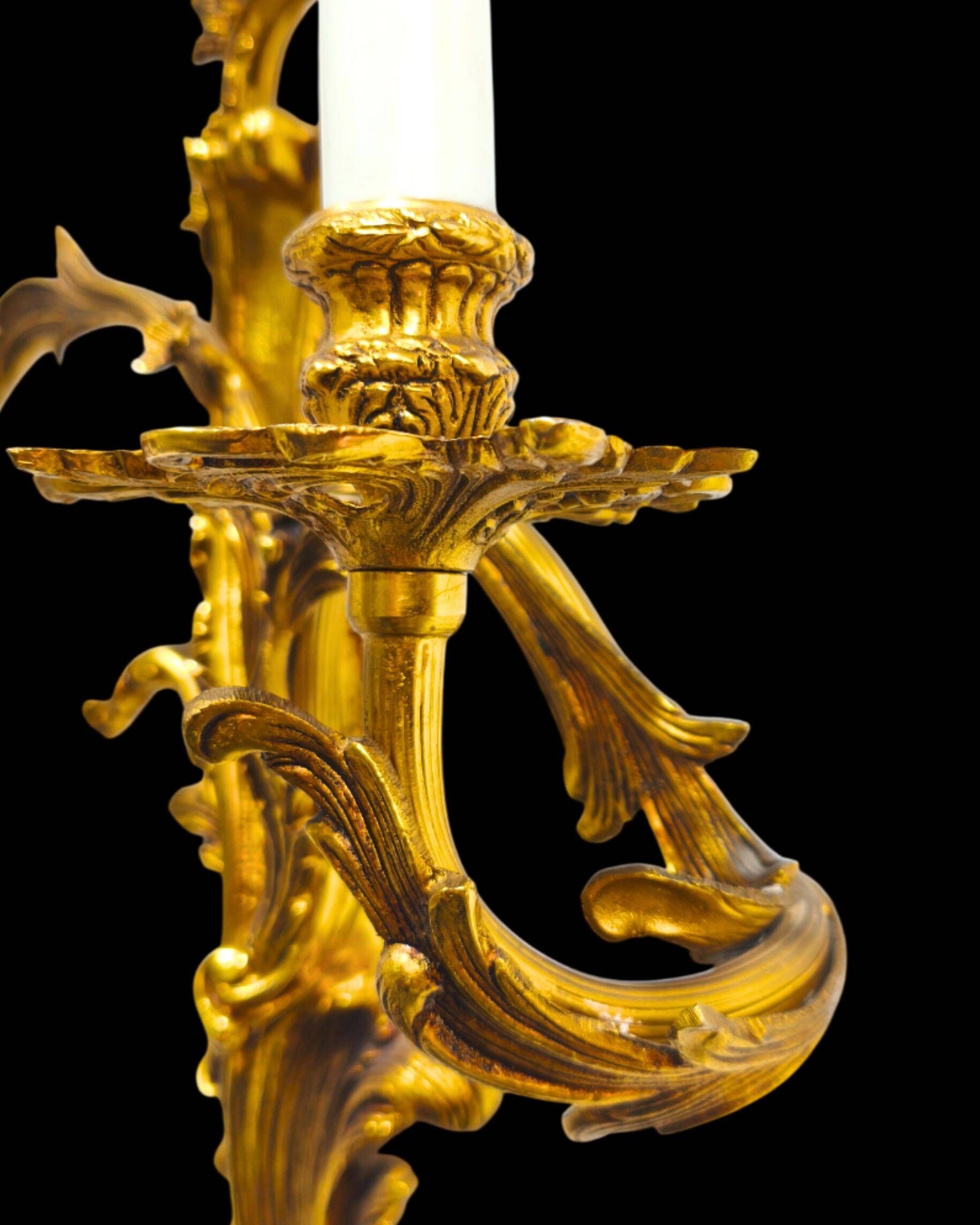 Pair of gilded bronze wall sconces in Rococo style, three lights.