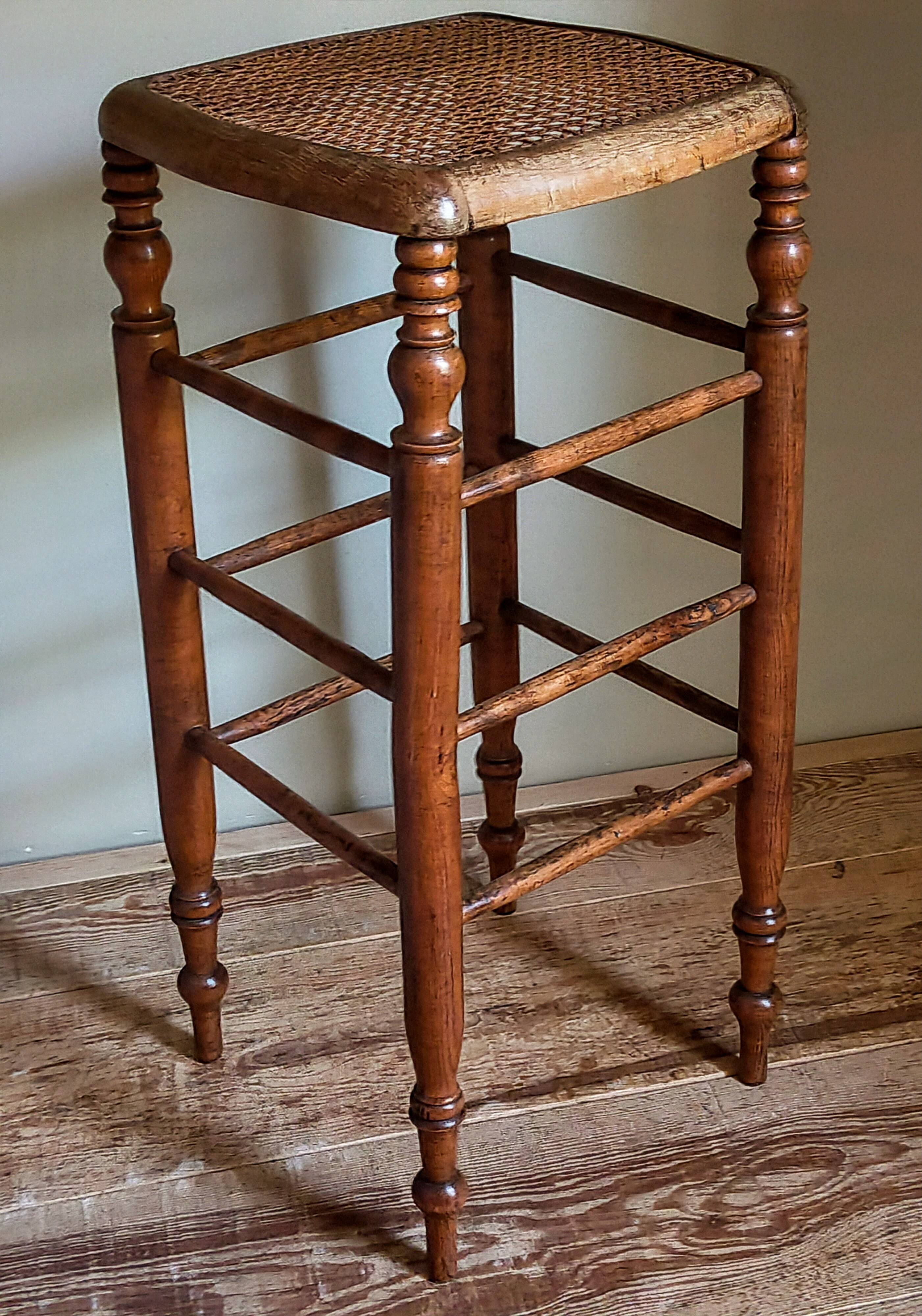 Antique stool with cane and turned wood
