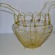 Old egg basket in yellow metal wire