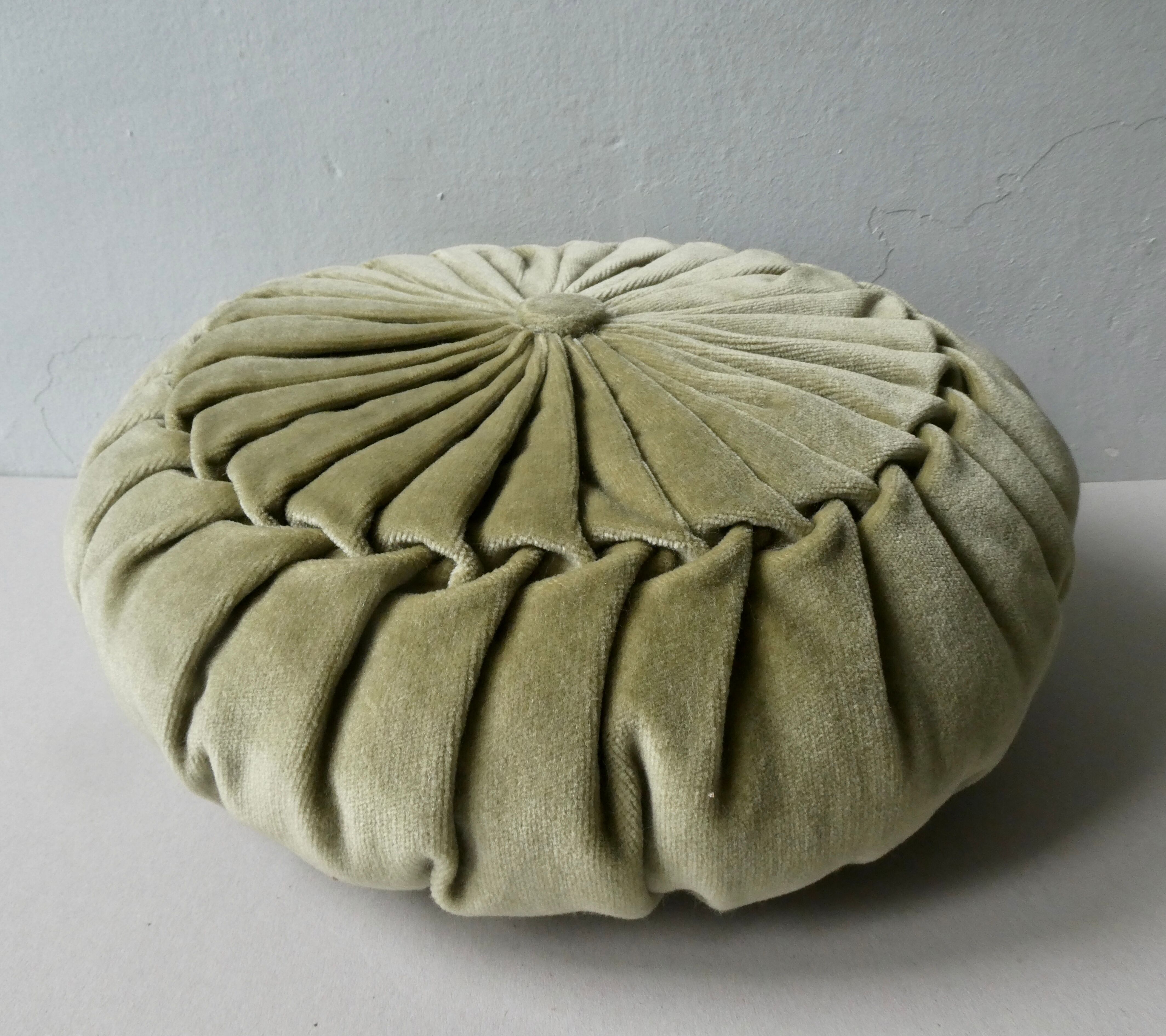 Pleated round cushion, almond green velvet